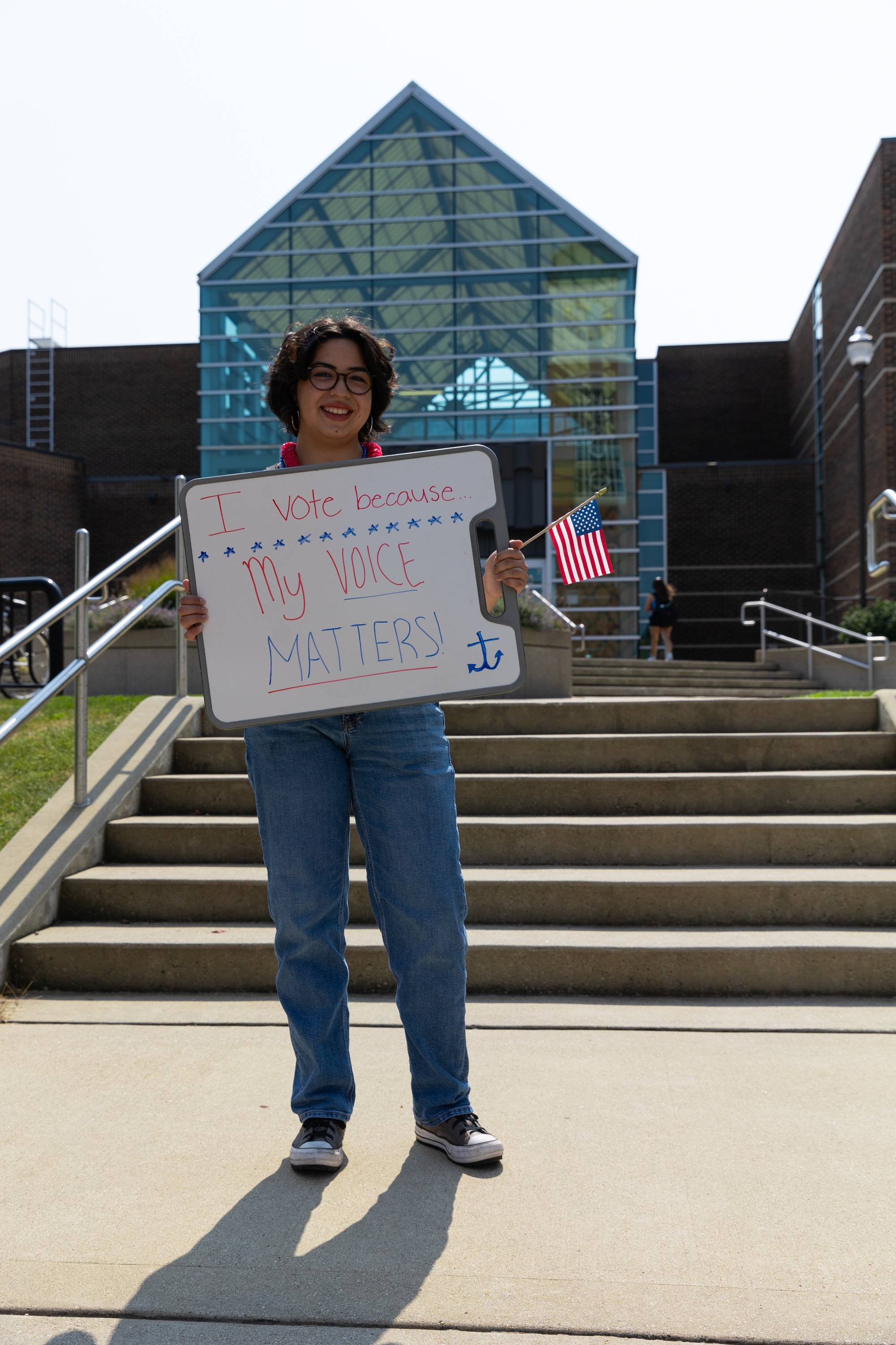 Person holding I vote because my voice matters sign